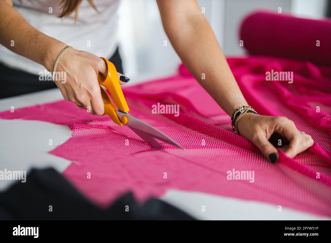 Gros plan sur le tissu de coupe des mains d'une femme Banque D'Images