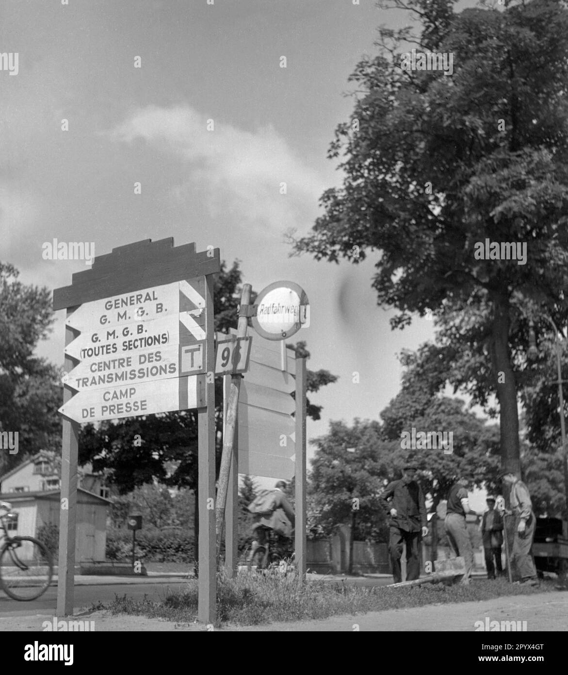 Photo des panneaux français dans le quartier français de Wedding (Berlin) à un carrefour dans Oranienburger Strasse, Bundesstrasse 96. Les panneaux indiquent le quartier général des forces d'occupation françaises, le quartier Napoléon (aujourd'hui Julius-Leber-Kaserne, Kurt-Schuhmacher-Damm 41, mariage, site du bataillon de garde d'aujourd'hui). Sur la droite sur le bikeway, les cyclistes et les voyageurs. Banque D'Images