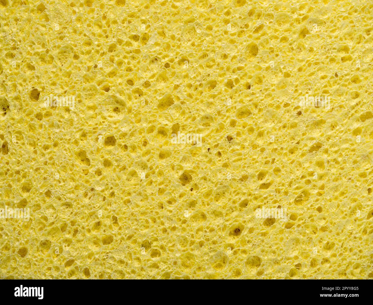 Arrière-plan abstrait avec texture de l'éponge de lavage jaune en gros plan Banque D'Images