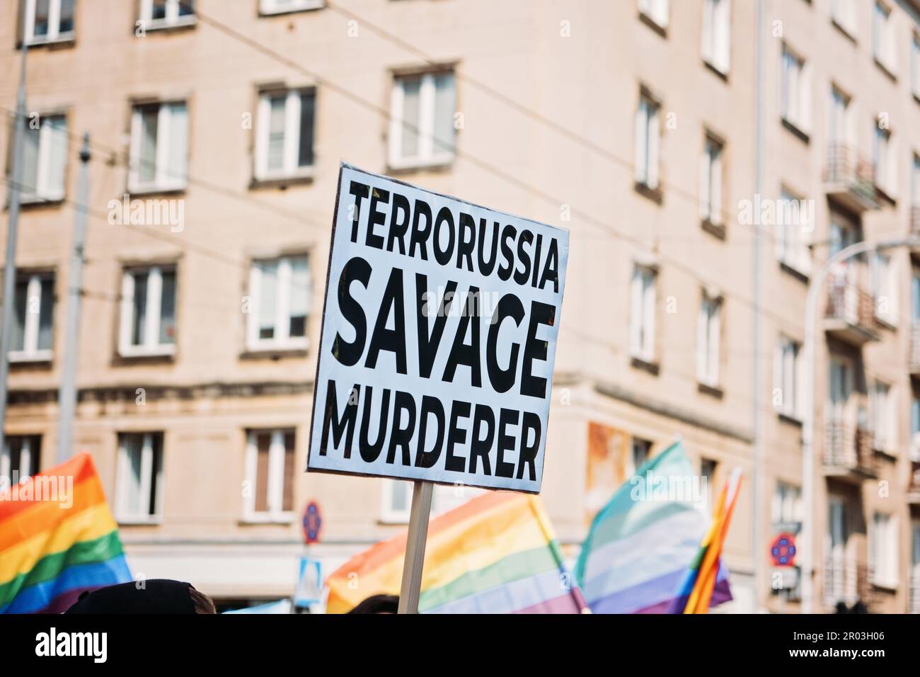 Fierté gay, la marche de solidarité LGBTQ avec des drapeaux arc-en-ciel et des affiches antiguerrières. Mains tenant une affiche avec des affiches antiguerrières. Défilé de l'égalité. Varsovie, Pologne Banque D'Images