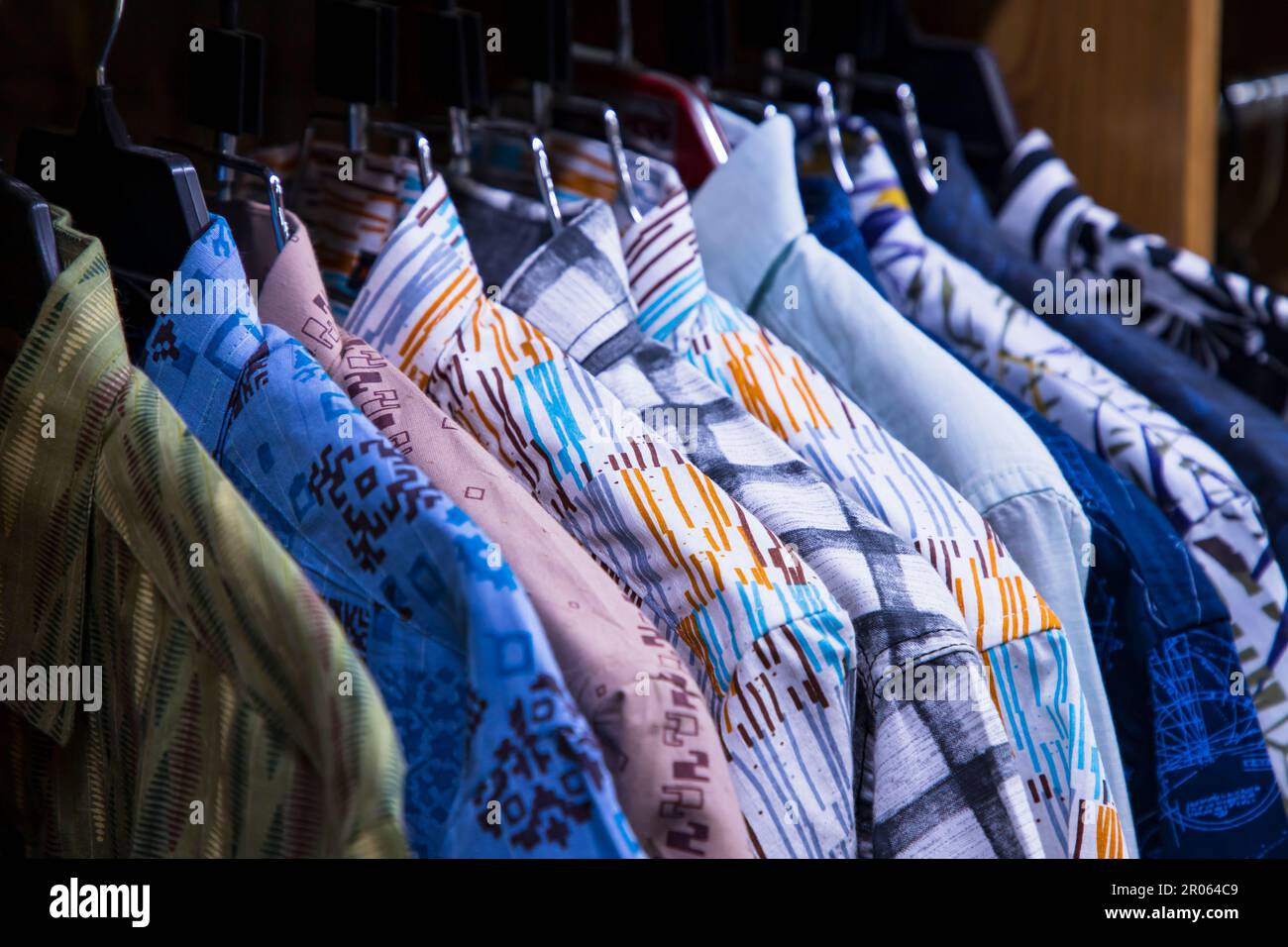 Variété colorée de tentures de chemises dans une salle d'exposition de vêtements. Mise au point rapprochée Banque D'Images