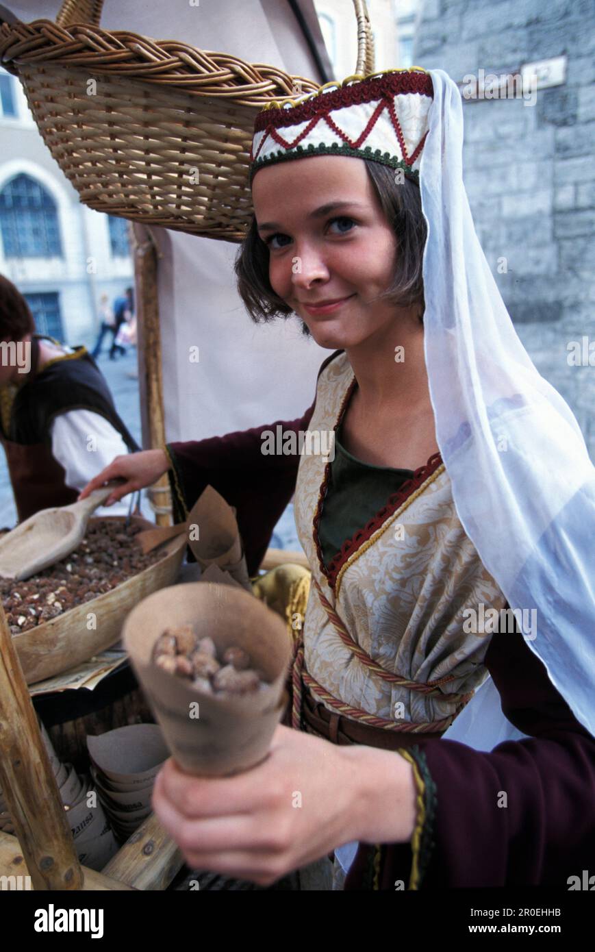 Jeune femme vendant des amandes devant le restaurant Olde Hansa, Tallinn, Estonie, Europe Banque D'Images