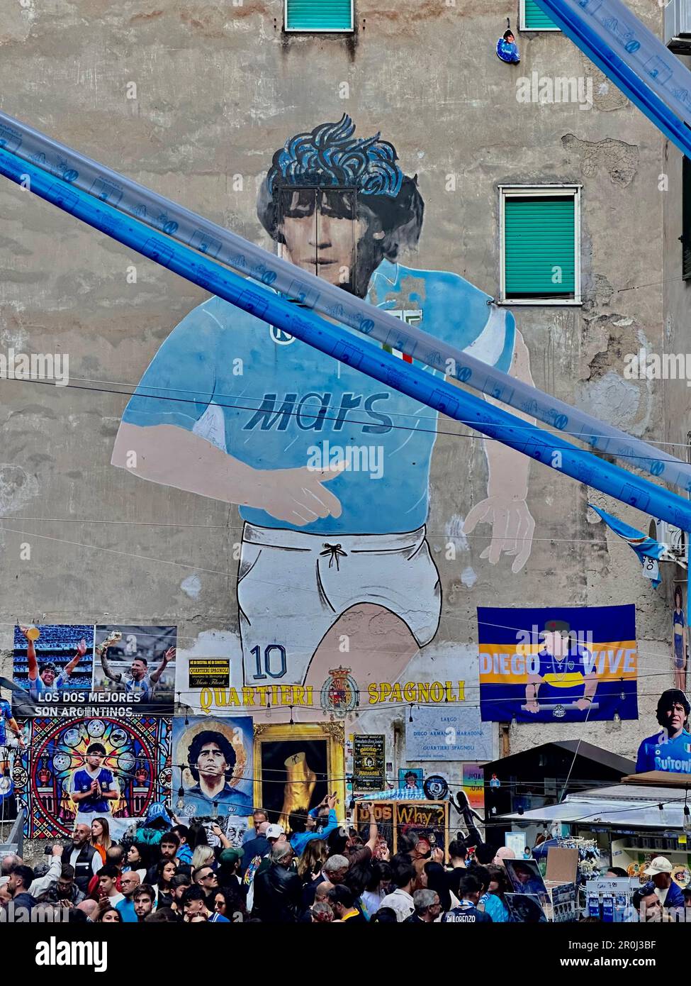 Naples Champions of Italy.NAPLES, ITALY - MAY 06: La fresque représentant Diego Armando Maradona dans le quartier Sapgnoli et drapeaux, bannières et rubans exposés à Forcella pour célébrer la victoire du troisième championnat Serie A. Des décorations ont été mises en place dans les rues du centre historique et dans les différents quartiers de Naples, drapeaux et bannières célébrant le championnat de football joué par l'équipe entraînée par Spalletti. Trente-trois ans après le dernier de l'ère de Diego Armando Maradona. Rues pleines de bannières avec des hymnes pour l'équipe et de nombreux magasins vendant des T-shirts et beaucoup d'autres g Banque D'Images