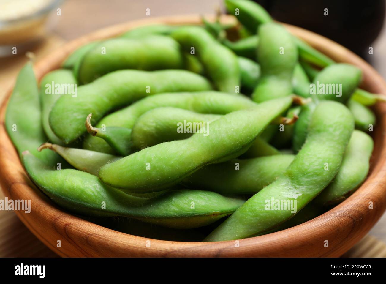 Bol contenant des haricots verts en forme d'edamame dans des dosettes, gros plan Banque D'Images