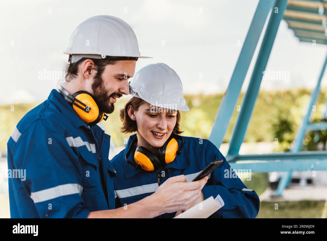 Les ingénieurs du solaire examinent visuellement les panneaux sur les sites de ferme à l'aide de plans et de dessins pour s'assurer que l'alignement, la surface, l'accès au soleil, et Banque D'Images