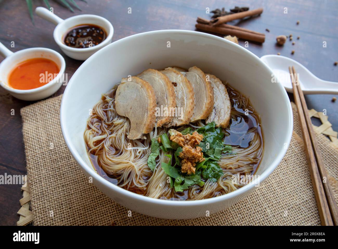 Soupe de nouilles de canard - braisée de nouilles de canard dans un bol blanc de table en bois à vue rapprochée, cuisine asiatique Banque D'Images