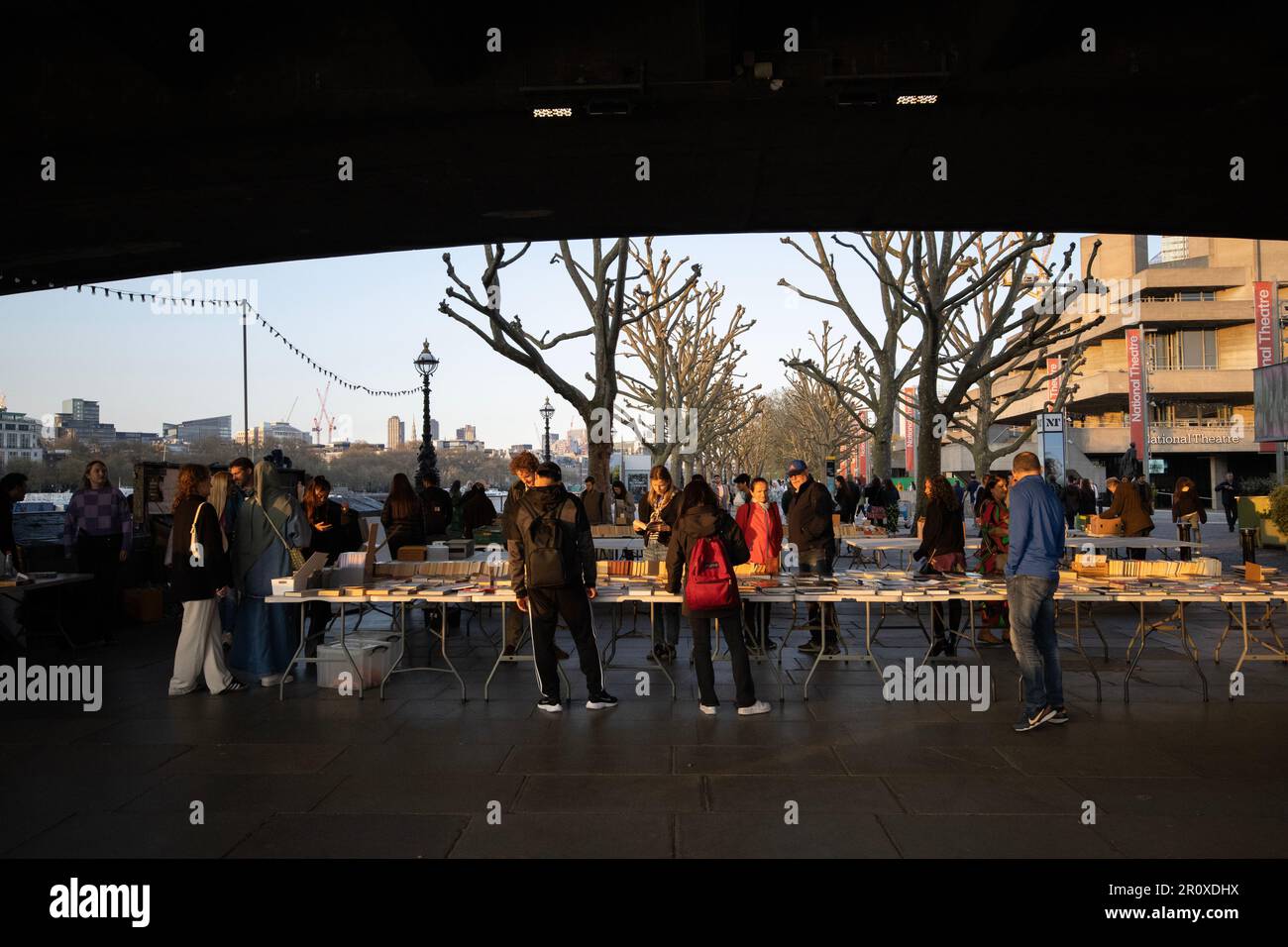 South Bank Book Market, les touristes s'arrêtent pour parcourir un marché de livres en plein air consacré uniquement aux livres situés sous le Waterloo Bridge, Londres, Royaume-Uni Banque D'Images