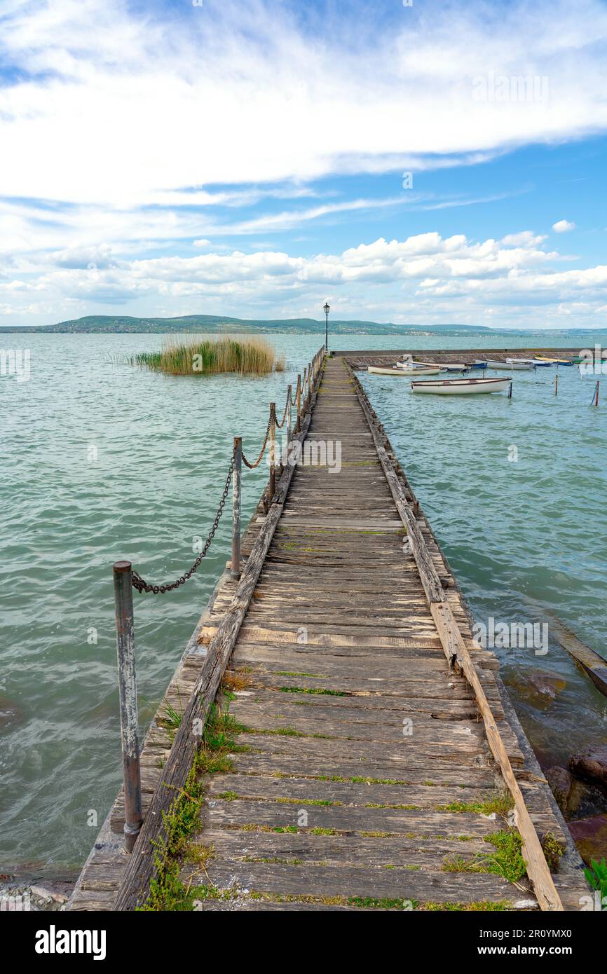 Jetée en bois à Balatonlelle avec des bateaux colorés sur le lac Balaton ciel bleu et eau . Banque D'Images