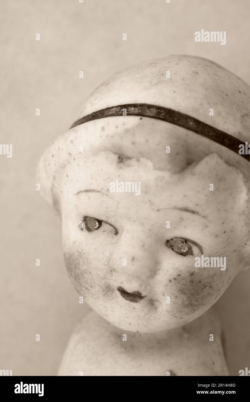 Image sépia de la tête de 1920 poupée de fille en porcelaine avec les grands yeux et le visage innocent Banque D'Images
