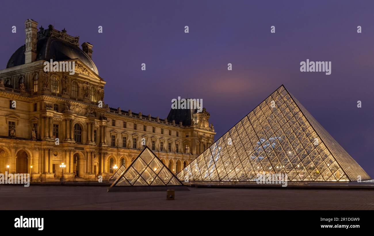 Le Louvre à Paris, France. Pyramides de verre la nuit dans le célèbre musée. Banque D'Images