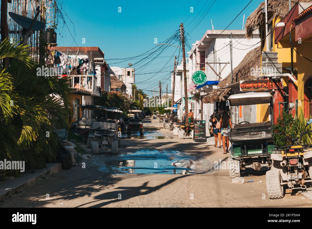 Les voiturettes de golf bordent les rues de terre de la petite ville insulaire d'Isla Holbox, au Mexique Banque D'Images