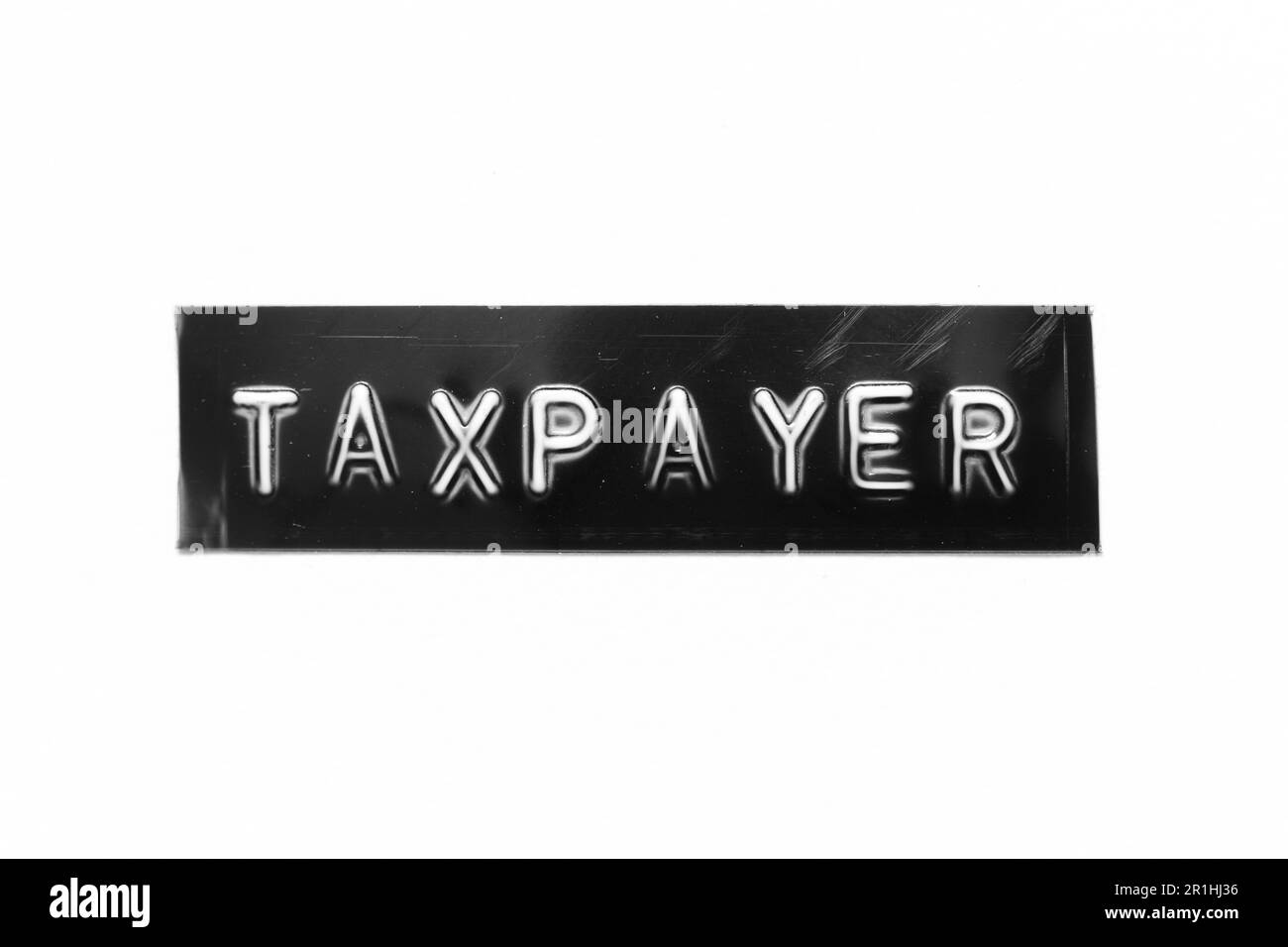 Bannière noire avec lettre en relief et mot contribuable sur fond de papier blanc Banque D'Images