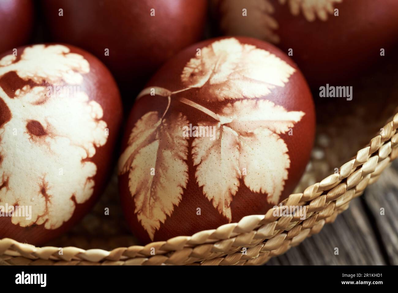 Gros plan de l'œuf de Pâques brun teint avec des peaux d'oignon dans un panier Banque D'Images