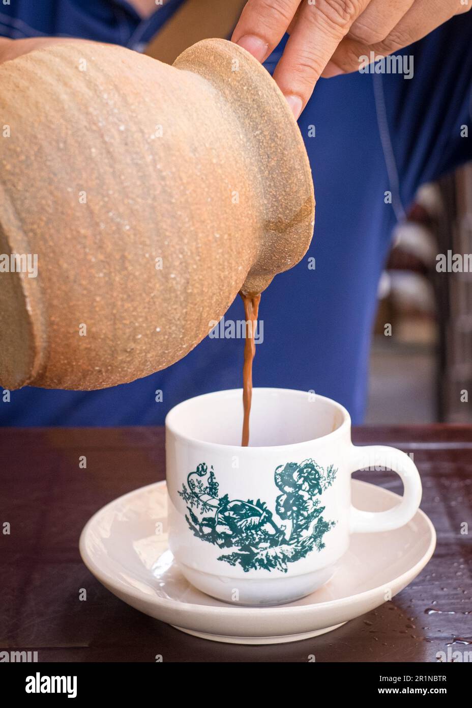 Homme qui verse du café dans un pot à café. Vue rapprochée. Banque D'Images