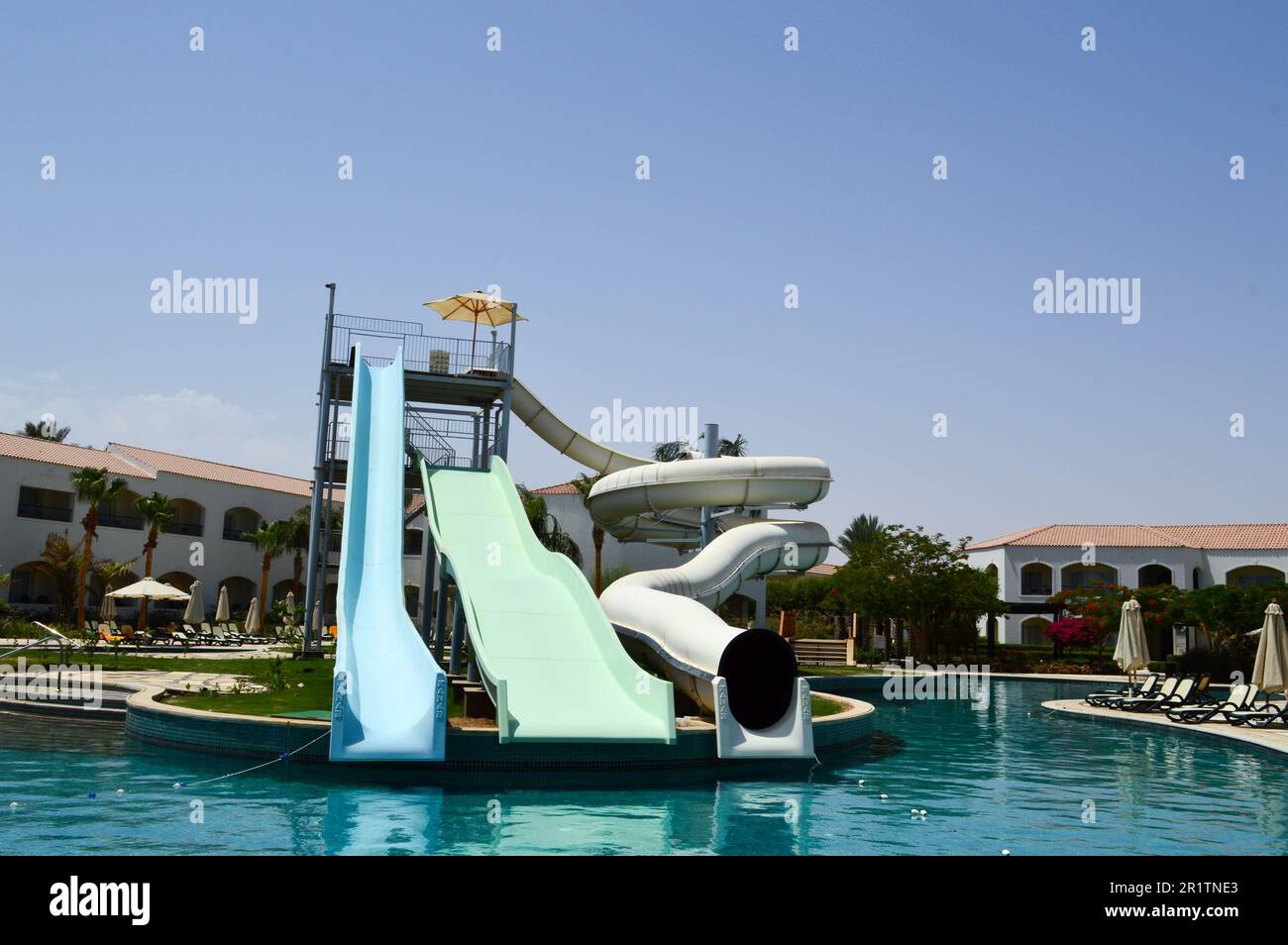 Piscine extérieure avec eau chaude bleue claire et toboggans aquatiques