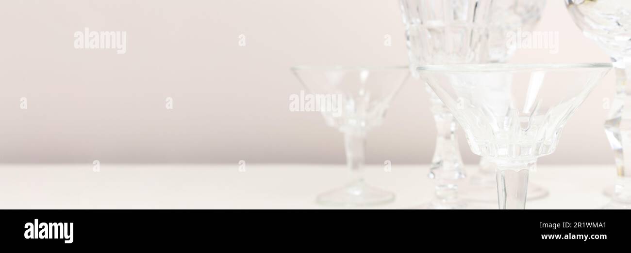 Bannière avec verres en cristal devant un fond beige. Concept minimal. Banque D'Images