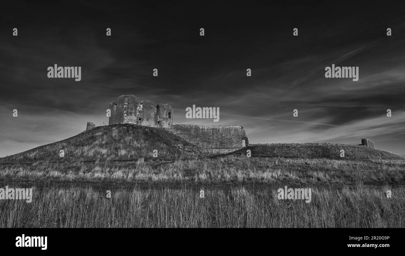 L'ancien château de Duffus est en ruines au sommet d'une colline rocheuse, entourée de nuages et de ciel couvert Banque D'Images