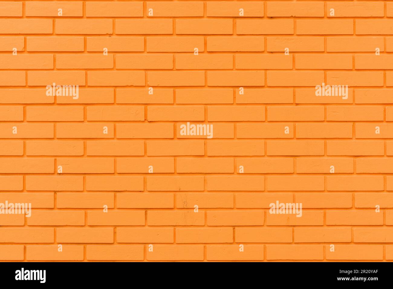 Motif de mur en briques orange vif comme élément graphique et arrière-plan. Texture de la surface extérieure d'une maison. Banque D'Images