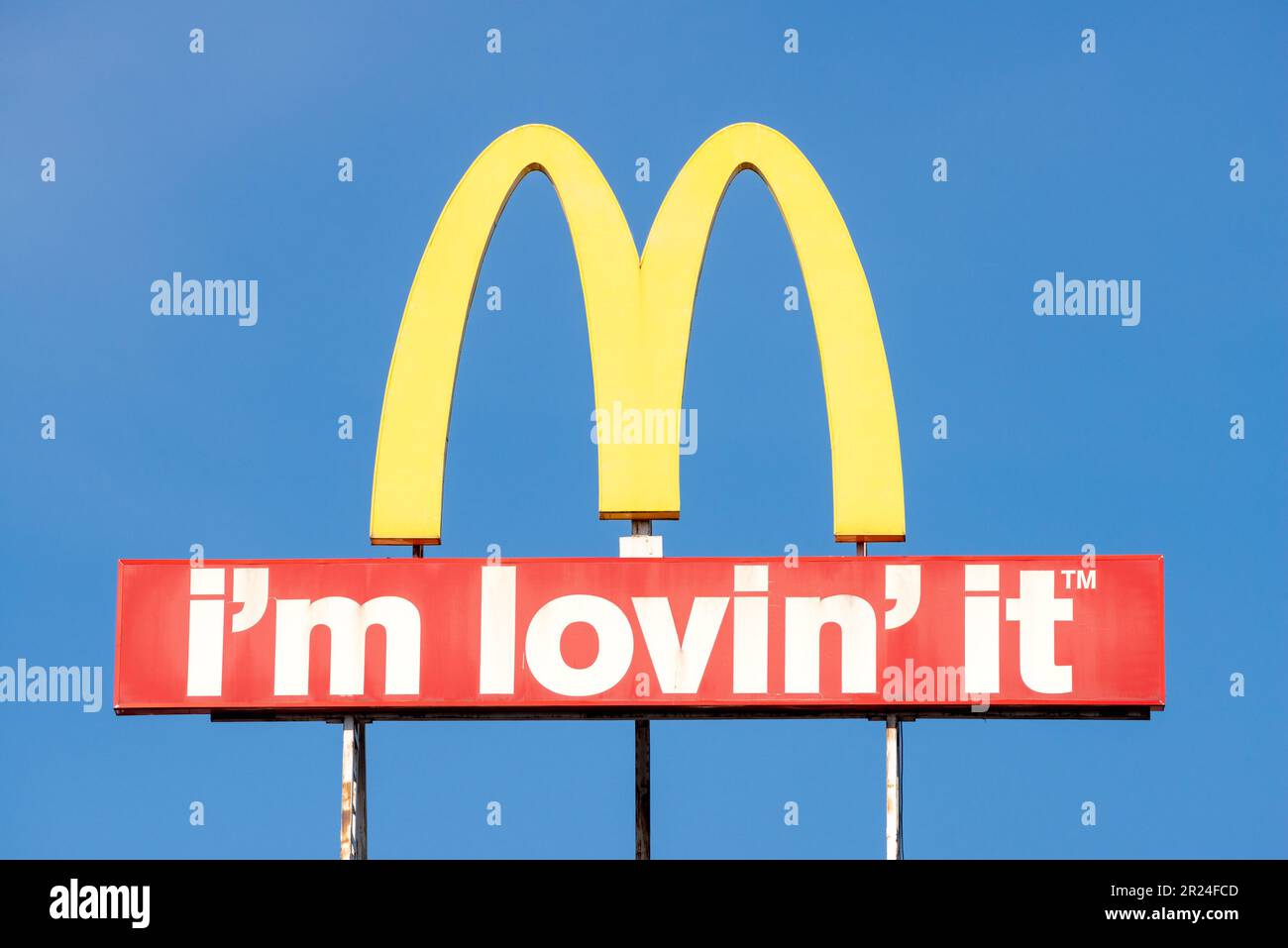 Le logo McDonald's marque Arches et le texte « I'm lovin » IT contre le ciel bleu avec espace de copie Banque D'Images