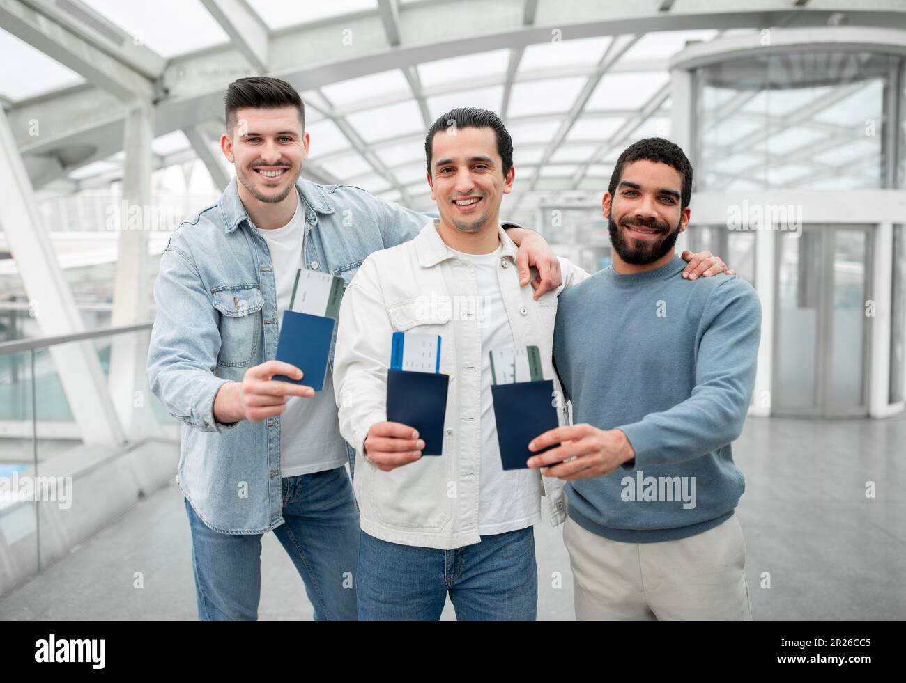 Trois touristes gaies montrant leurs cartes d'embarquement à l'aéroport Banque D'Images