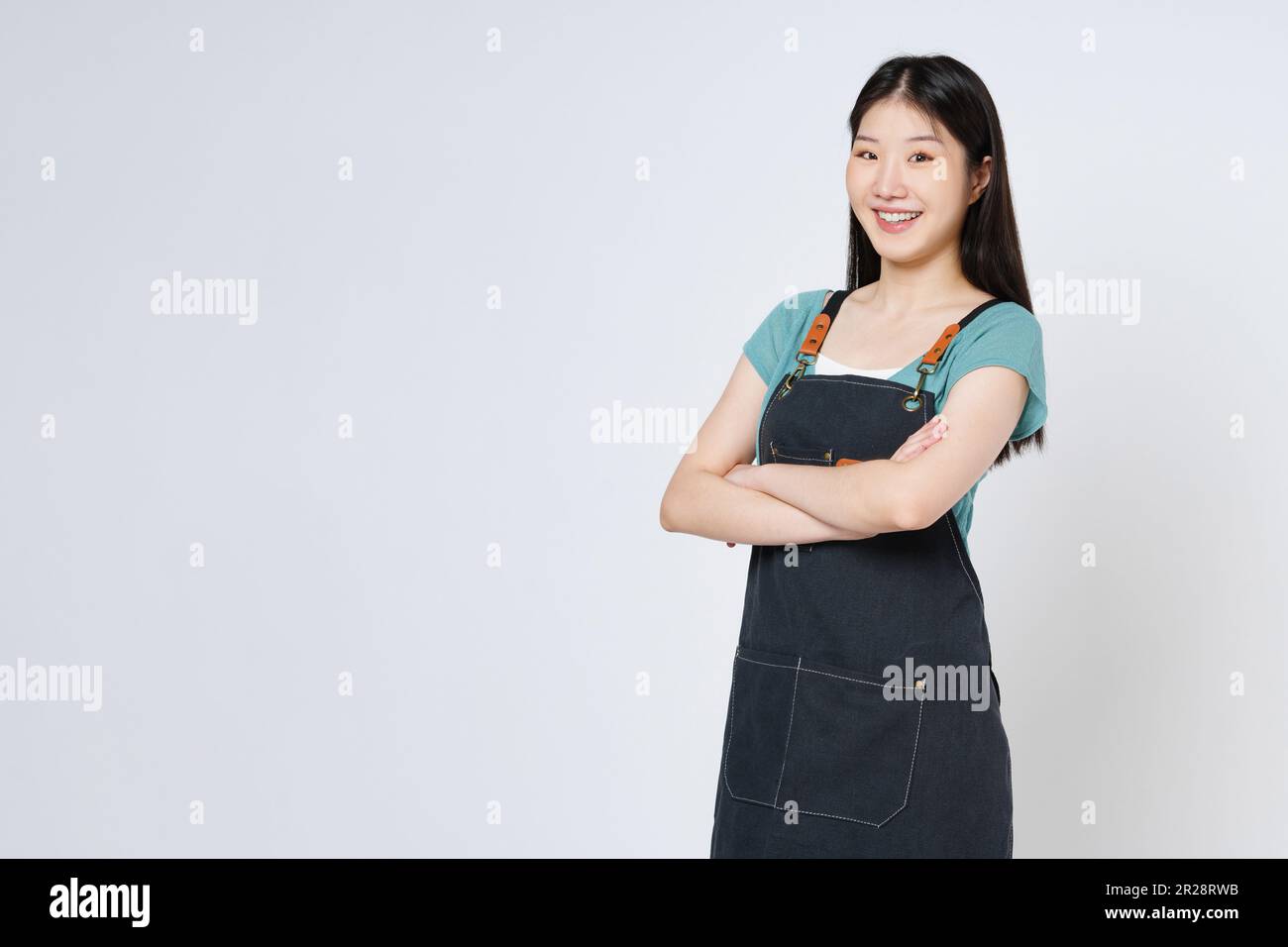 Femme heureuse chef ou cuisinier dans un tablier isolé sur fond blanc. Banque D'Images