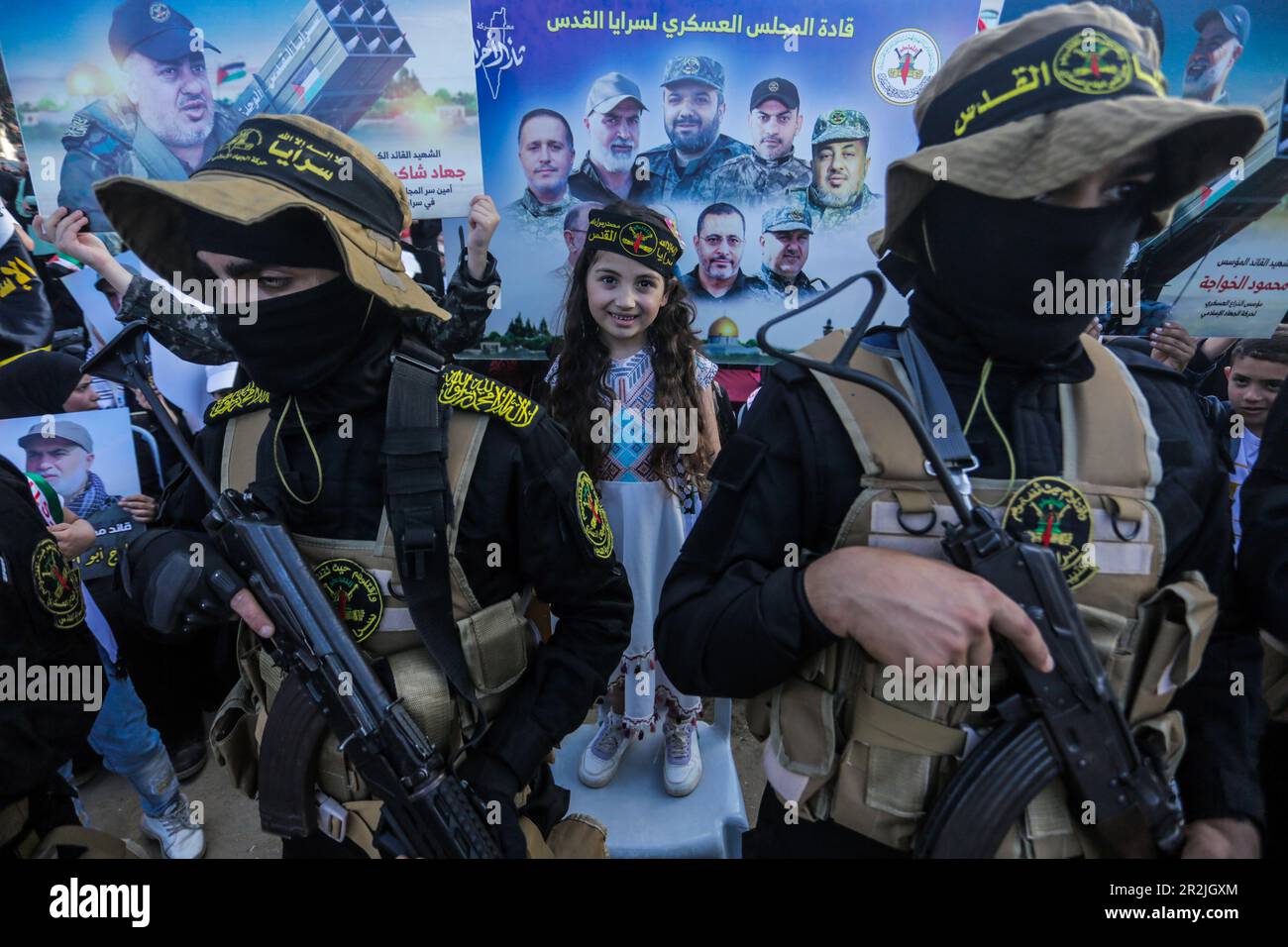 Gaza, Palestine. 19th mai 2023. Une fille palestinienne se tient parmi les combattants du Jihad islamique lors d'un rassemblement pour commémorer les commandants et les agents du groupe tués par Israël dans le récent conflit transfrontalier, à Gaza. Crédit : SOPA Images Limited/Alamy Live News Banque D'Images