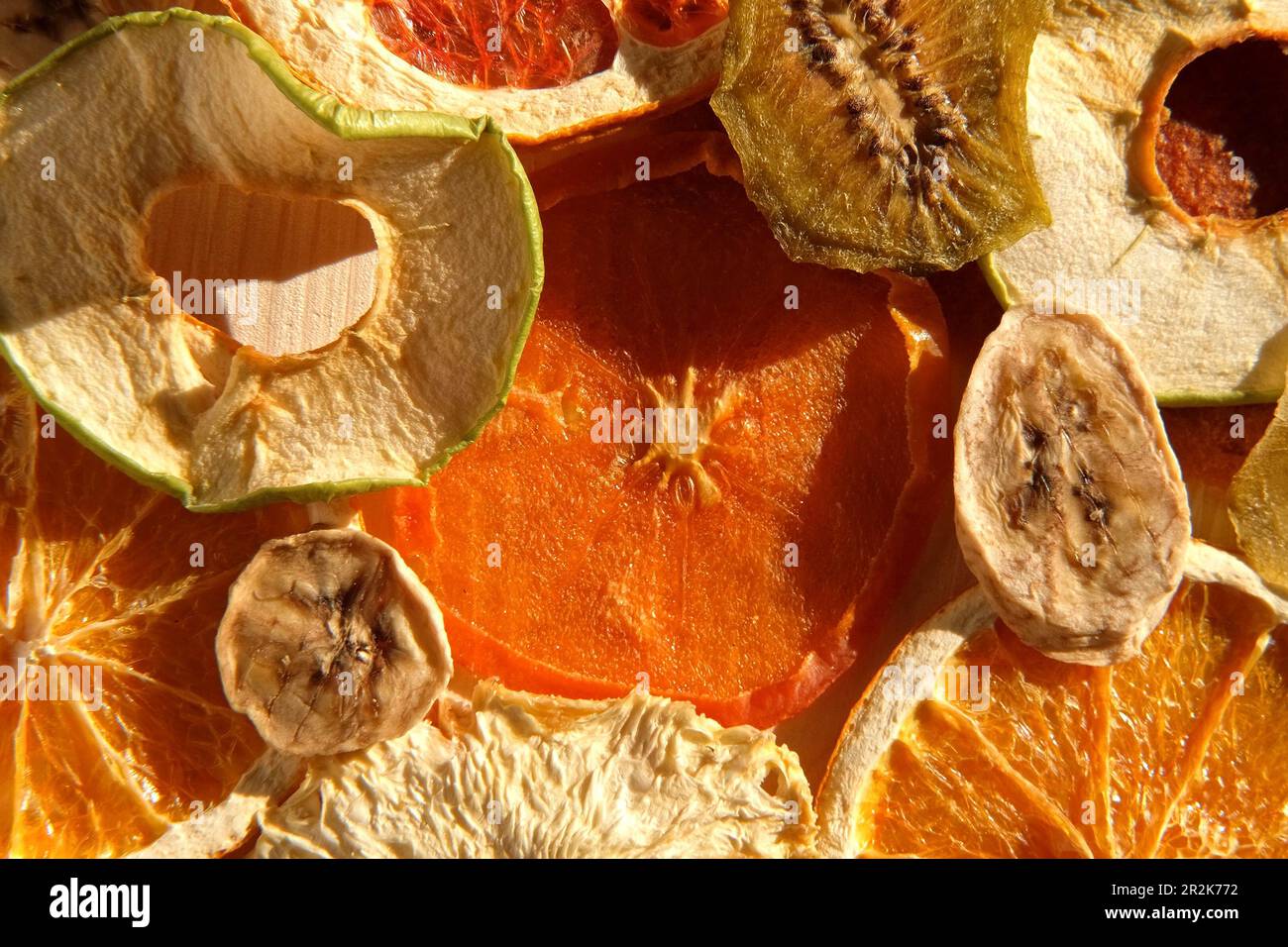 Fruits secs. Assortiment de fruits biologiques séchés au soleil sur fond de bois. Grignotage et cuisson. Mélange tendance de fruits secs et confits sli Banque D'Images
