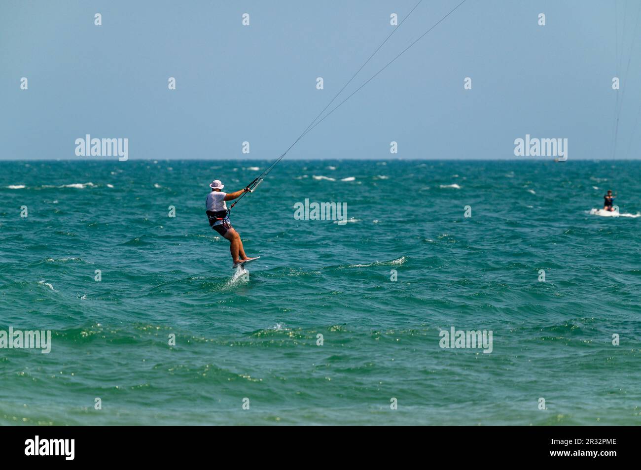Un kitesurfer passe son hydroptère au large de la plage de Mui ne, Vietnam. Banque D'Images