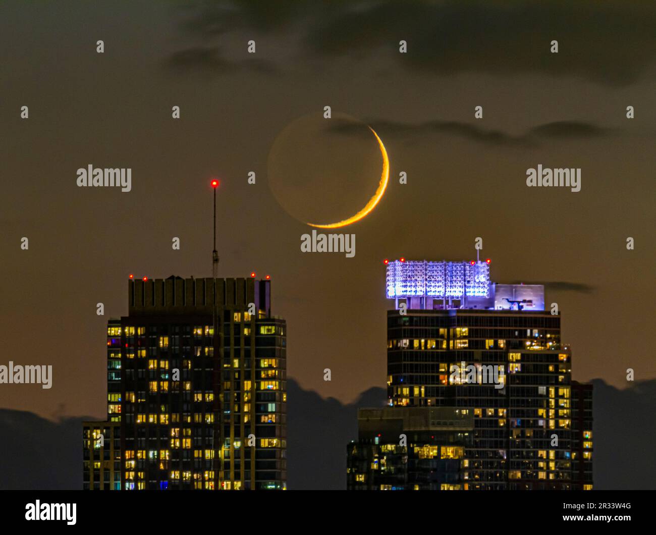 Cirage Crescent Moon au-dessus de la vue de Lower Manhattan depuis une fenêtre à Williamsburg, Brooklyn. Banque D'Images