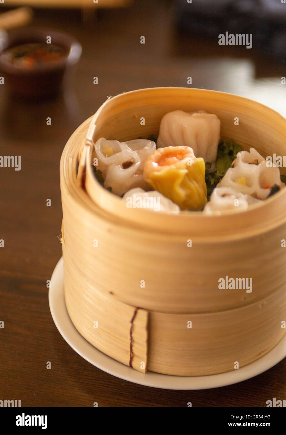 Dim Sum cuit à la vapeur dans un panier avec baguettes Banque D'Images