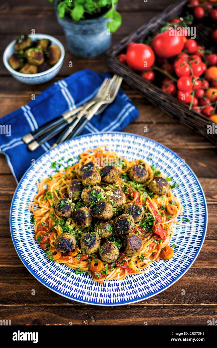 Vegan aubergine boulettes de viande sur un lit de spaghetti à la sauce tomate et olives Banque D'Images