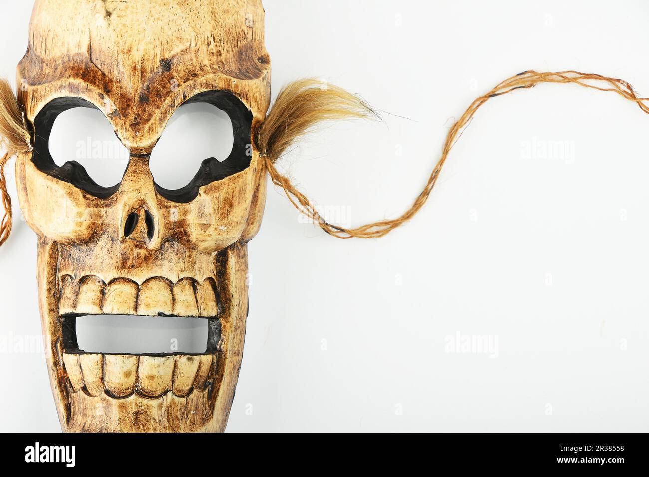 Masque de mort crâne en bois sculpté sur blanc Banque D'Images