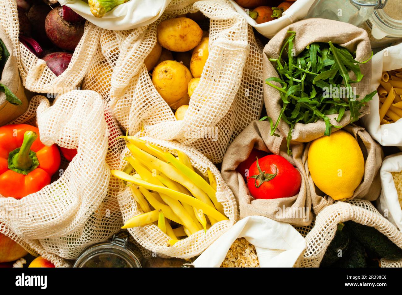 Légumes frais dans des sacs en coton écologique sur la table, vue sur le dessus Banque D'Images