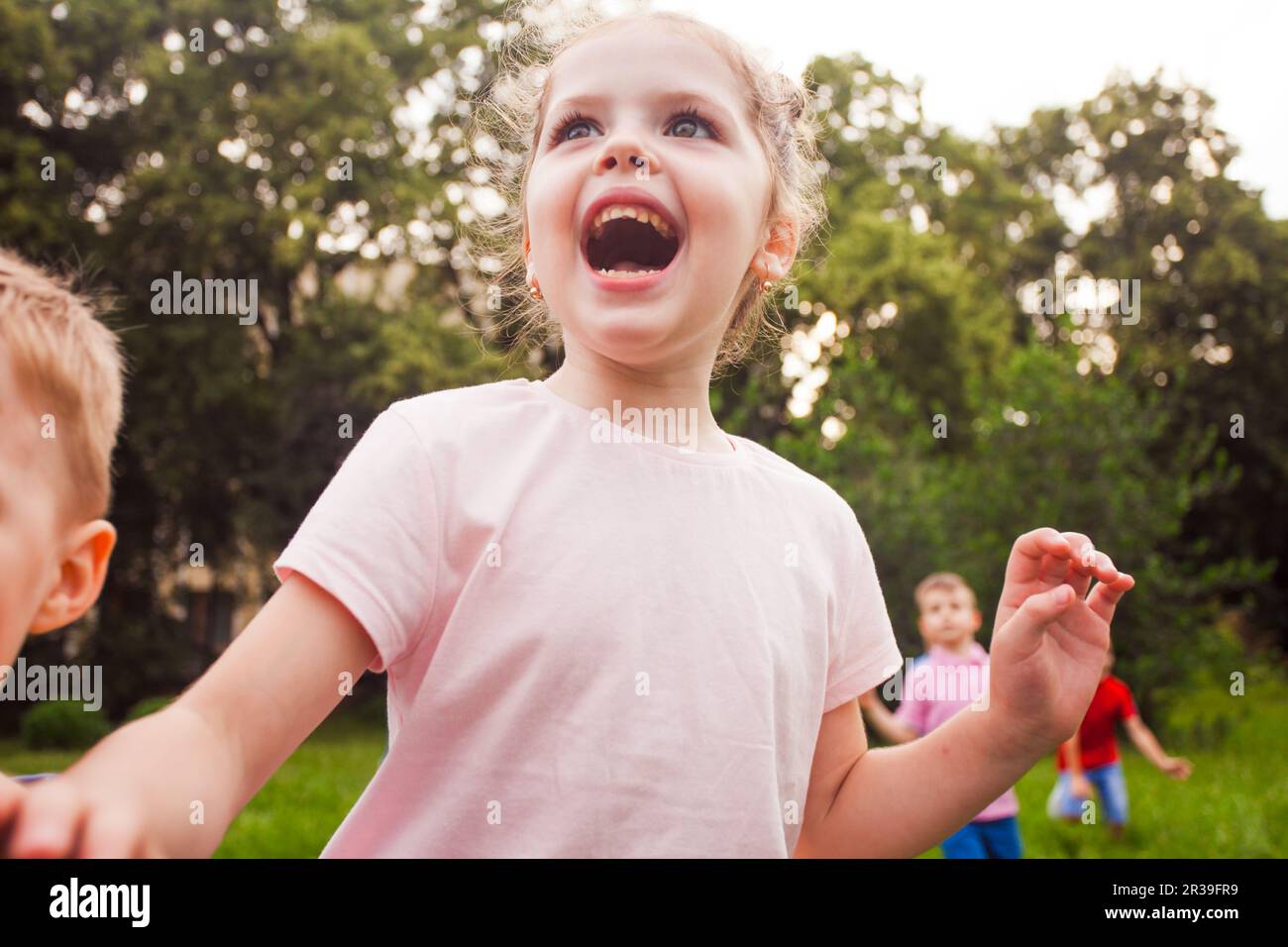 Joyeux enfant jouant sur la nature lors d'une fête d'anniversaire pour enfants Banque D'Images