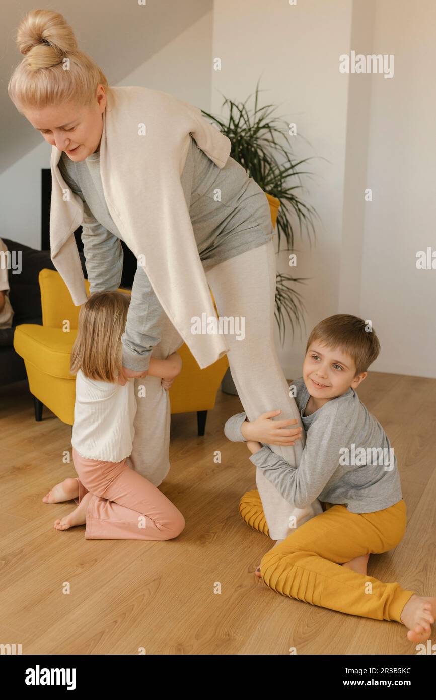 Petits-enfants jouant avec la grand-mère à la maison Banque D'Images