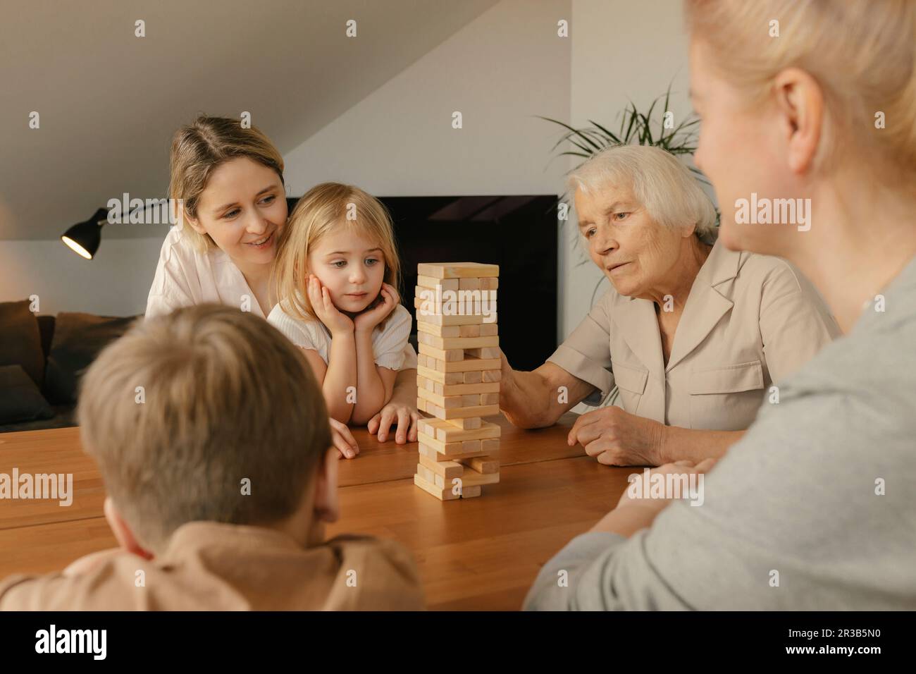Grand-mère jouant au jeu avec la famille à la maison Banque D'Images