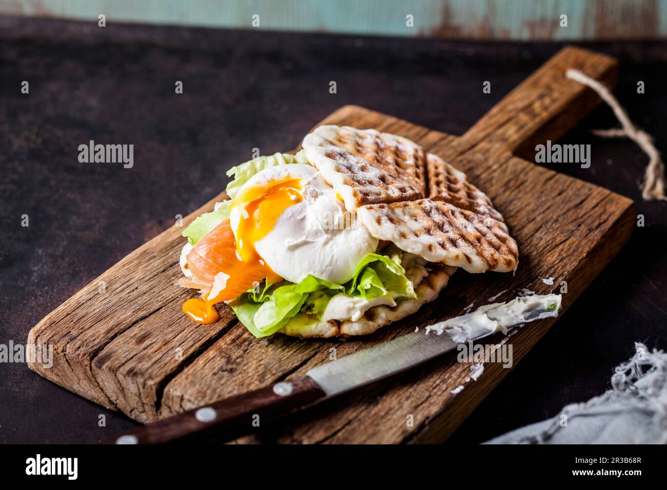 Sandwich gaufré avec du saumon et un œuf poché Banque D'Images