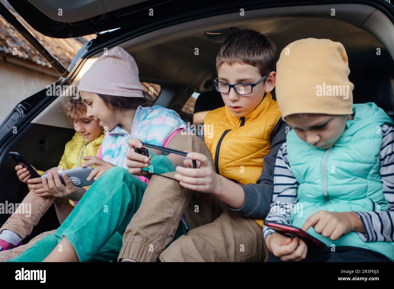 Enfants assis sur le camion avec un smartphone Banque D'Images
