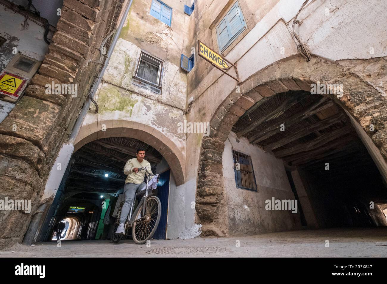 Garçon sur un vélo traversant Skala de la Kasbah, Essaouira, maroc, afrique. Banque D'Images