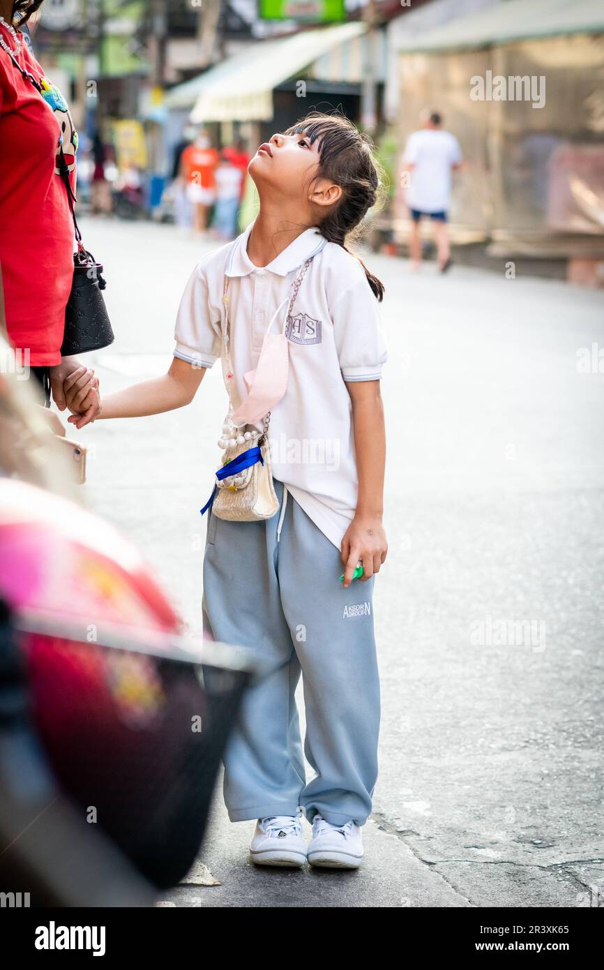 Une jeune fille thaïlandaise attend un trajet à la maison après l'école dans la ville de Thaïlande de Pattaya. Banque D'Images