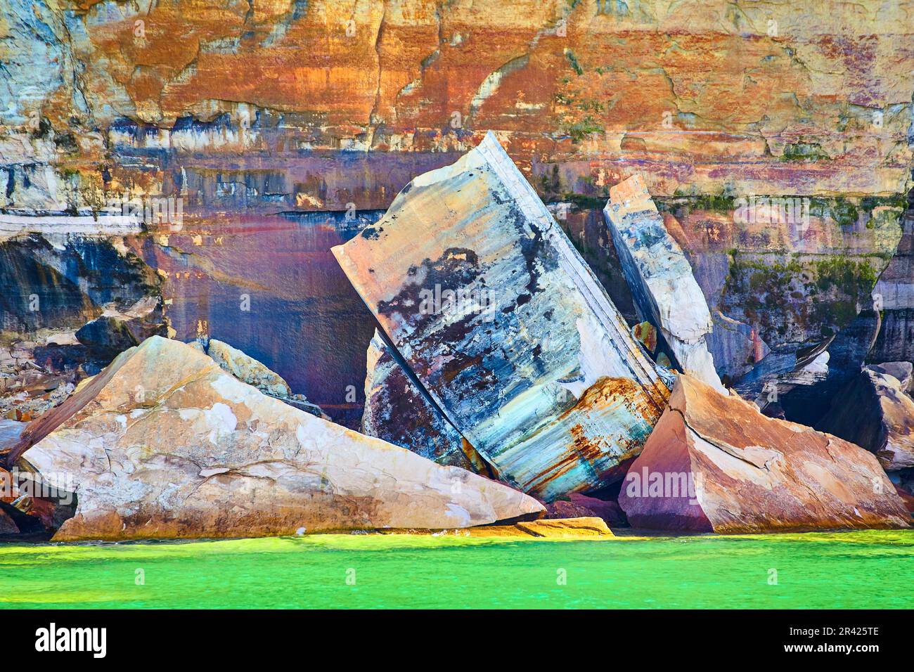 La falaise géante s'est effondrée avec des minéraux peints de Pictured Rocks dans une eau de lac verte et vibrante Banque D'Images
