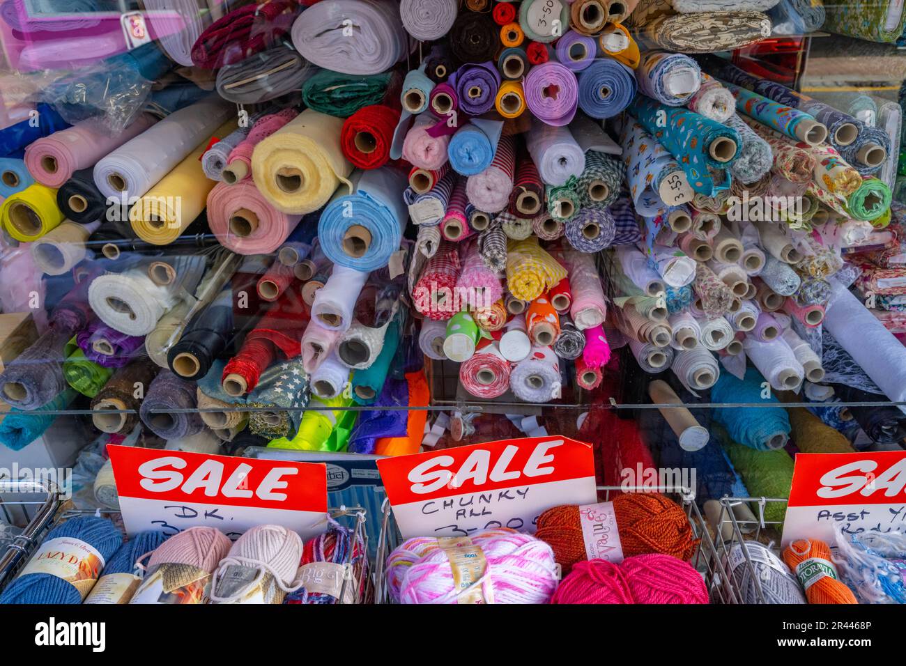 Rouleaux de tissu et balles de yarn dans une fenêtre de magasin Gravesend Kent Banque D'Images