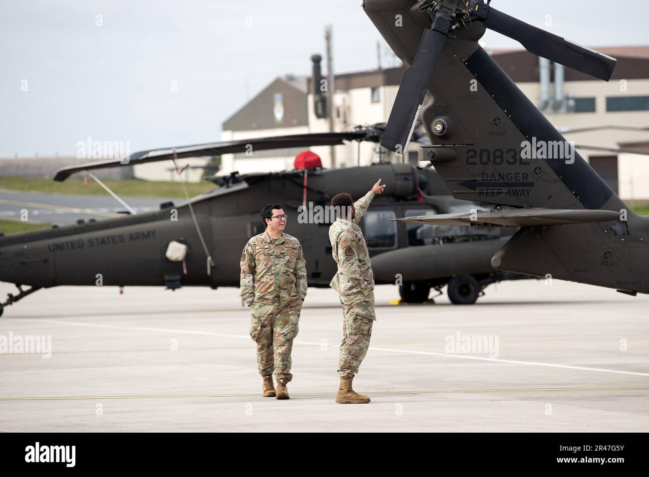 ÉTATS-UNIS Des aviateurs marchent le long de la ligne de vol à la base aérienne de Spangdahlem, en Allemagne, au cours d'une visite de trois FAUCONS NOIRS UH-60M affectés à la compagnie chaos, 3-501st Bataillon d'hélicoptères d'assaut, Brigade de l'aviation de combat de la première division blindée de fort Bliss, Texas, 20 mars 2023. L’avion sert d’hélicoptère de transport tactique utilitaire de l’Armée de terre. Banque D'Images