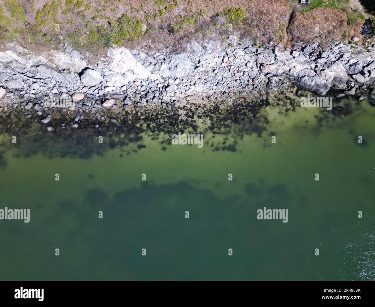 Une vue aérienne d'un front de mer tropical, mettant en valeur les eaux vives de vert émeraude et une abondance de rivage sablonneux, parsemé de formations rocheuses Banque D'Images Une vue aérienne d'un front de mer tropical, mettant en valeur les eaux vives de vert émeraude et une abondance de rivage sablonneux, parsemé de formations rocheuses Banque D'Images