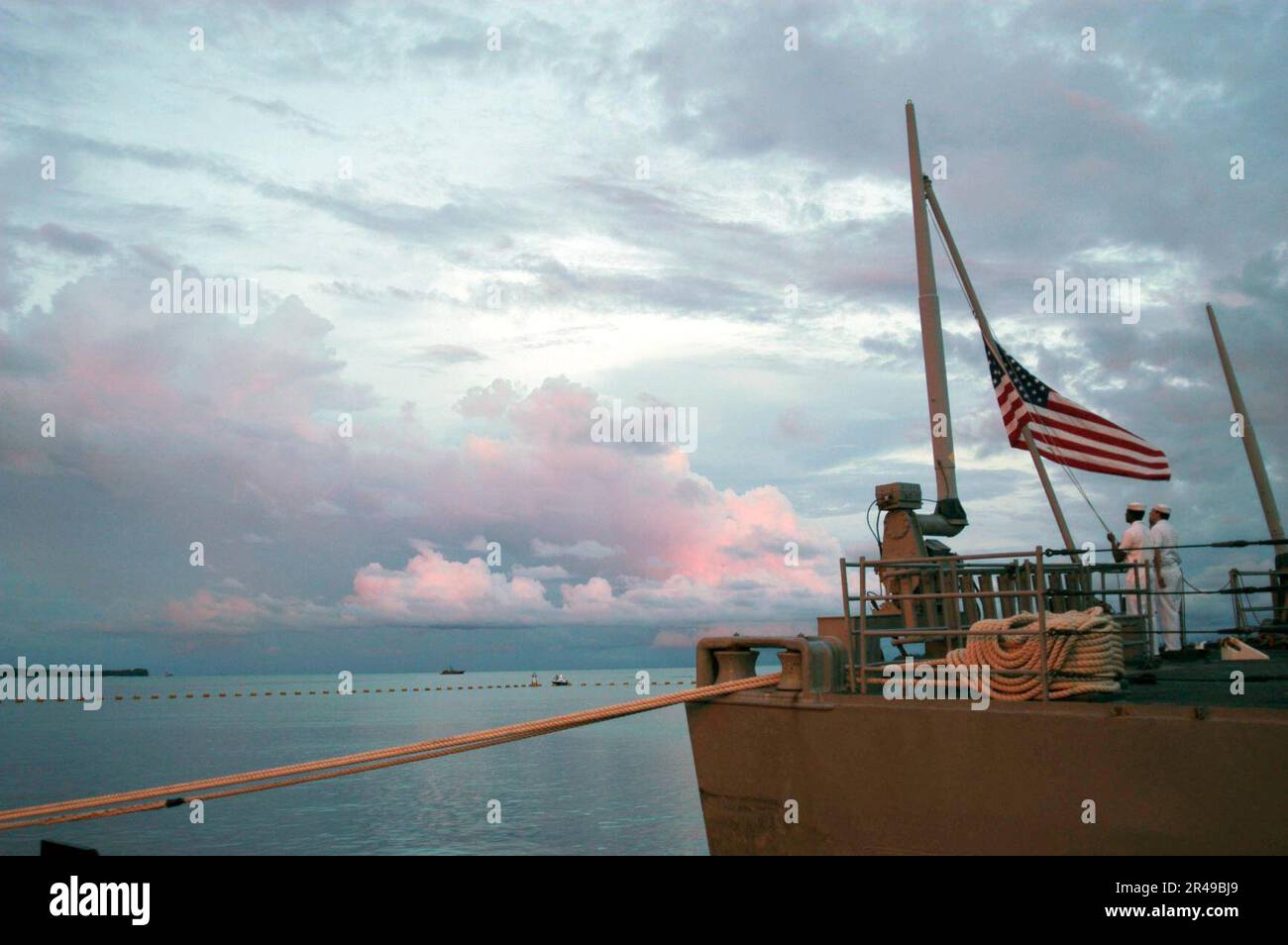 LES marins DE LA Marine AMÉRICAINE à bord du croiseur de missiles guidé USS Vincennes (CG 49) abaissent le drapeau lors de la cérémonie traditionnelle des couleurs du soir Banque D'Images