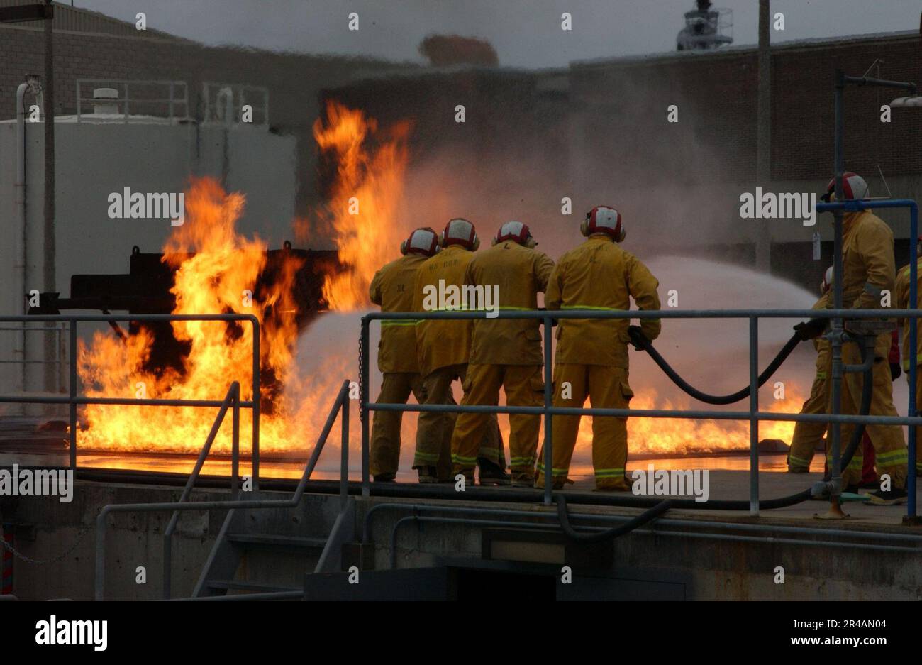 US Navy - Military Seallift Command Merchant Marine marins combat un feu de pont de vol simulé au cours de lutte contre l'incendie à bord du centre d'entraînement de la flotte, San Diego Banque D'Images