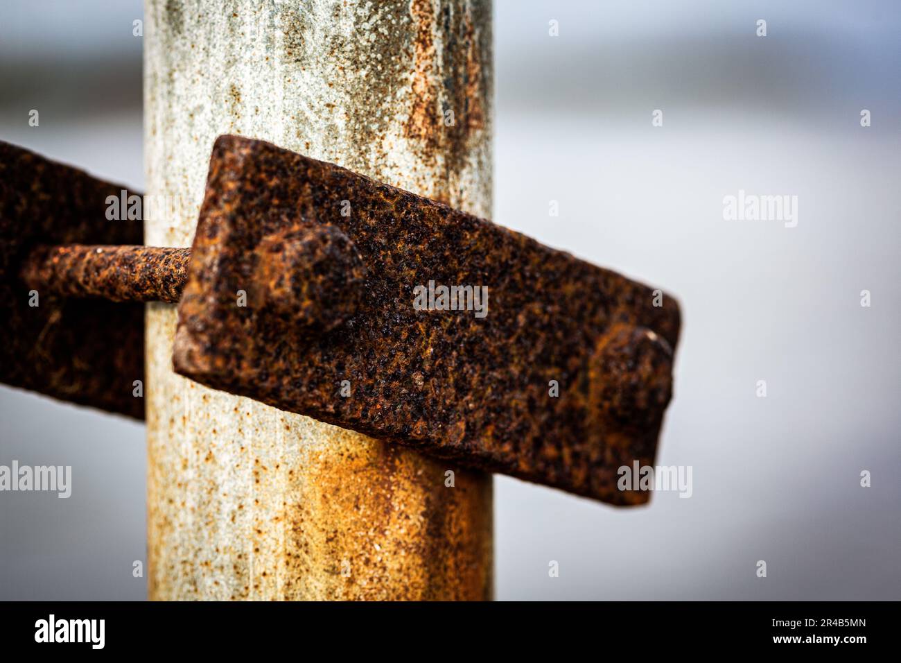 Un objet métallique ancien et abîmé est suspendu à un poteau métallique Banque D'Images