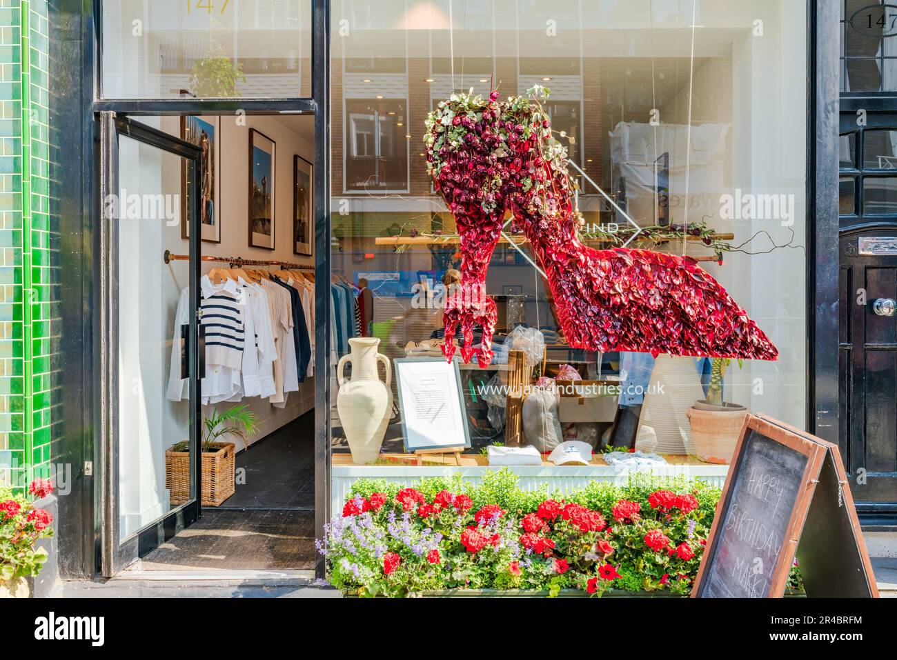 LONDRES, Royaume-Uni - 24 MAI 2023 : une exposition florale spectaculaire décore la fenêtre d'une boutique à Chelsea pendant le spectacle floral annuel de Chelsea à Bloom à Londres Banque D'Images