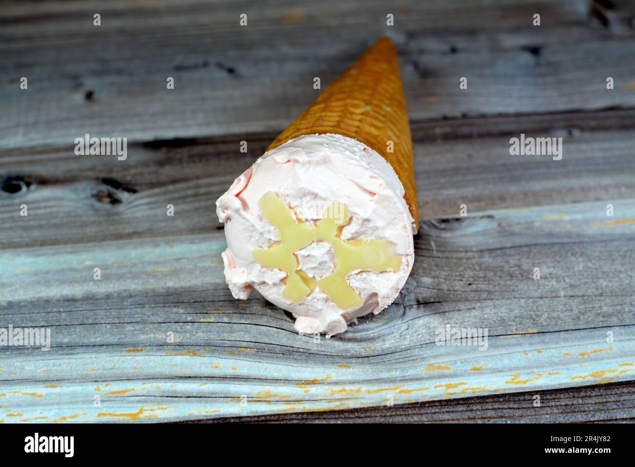 Crème glacée aux saveurs spéciales dans des cônes de cachets croustillants, la glace froide se mélange dans des biscuits de cachets isolés sur fond de bois, l'été et les vacances Banque D'Images