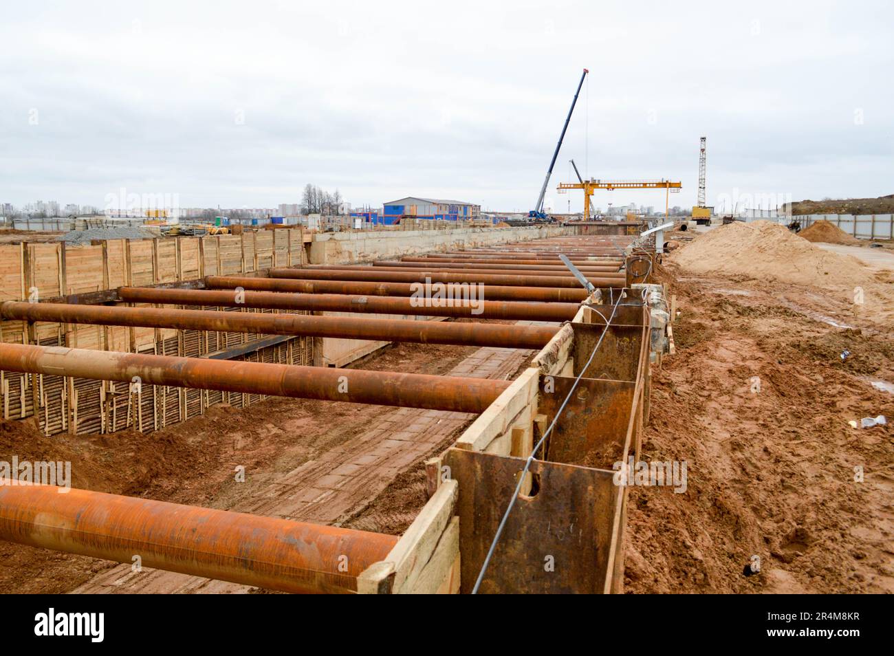 Un grand tunnel de fossé énorme avec des structures de renforcement de tuyaux en fer épais de poutres et de structures au site de construction du me souterrain Banque D'Images